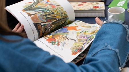 a child flipping through a picture bbook