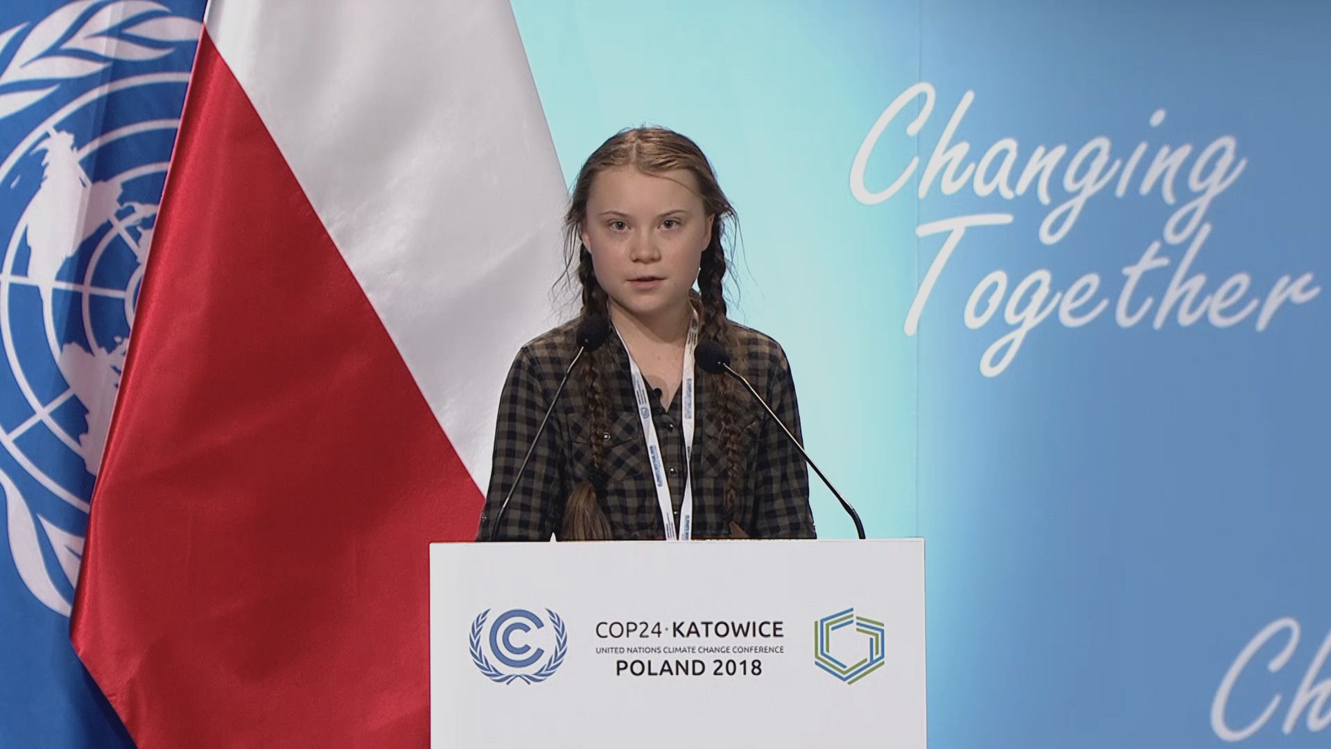 Greta Thunberg is speaking at a podium at the UN COP24 in Poland